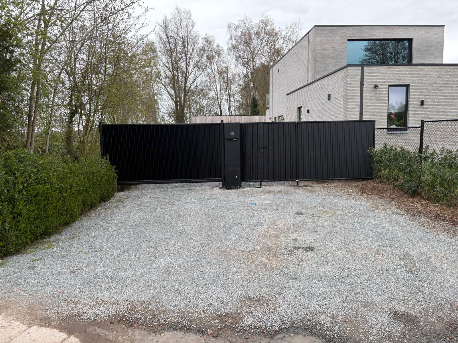 Moderne zwarte schuifpoort op maat door Metaalconstructies Meert